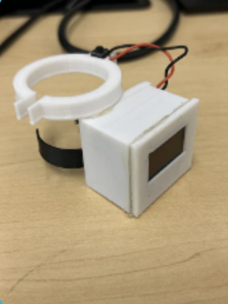 MediGuard Clip, back view: the ring that clips onto a pill bottle and the button